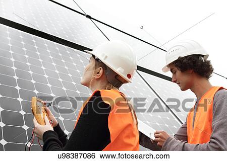 Man and woman working on photo voltaic panels View Large Photo Image Stock Photograph - Man and woman working on photo voltaic panels. Fotosearch