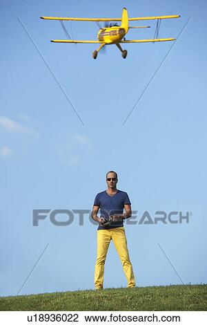 Man flying model plane View Large Photo Image Stock Image - Man flying model plane. Fotosearch