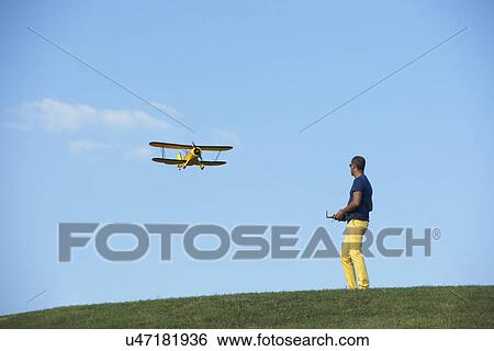Man flying model plane View Large Photo Image Stock Photograph - Man flying model plane. Fotosearch
