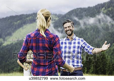 Man greeting woman with open arms, Tirol, Austria View Large Photo Image Stock Photo - Man greeting woman with open arms, Tirol, Austria. Fotosearch