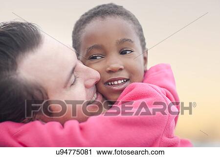 Stock Image - Man hugging child. Fotosearch