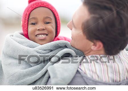 Man hugging child wrapped in blanket View Large Photo Image Stock Image - Man hugging child wrapped in blanket. Fotosearch
