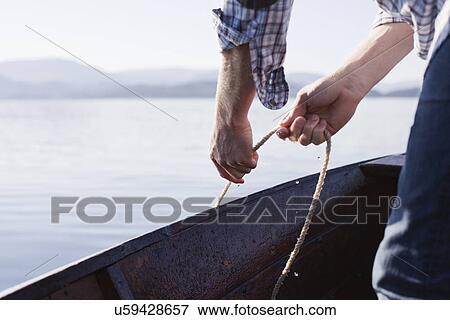 Man on boat with rope, Aure, Norway View Large Photo Image Stock Photo - Man on boat with rope, Aure, Norway. Fotosearch