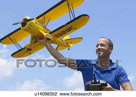 Man preparing to launch model plane View Large Photo Image Stock Image - Man preparing to launch model plane. Fotosearch