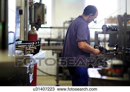 Man working in industrial wine cellar View Large Photo Image Stock Image - Man working in industrial wine cellar. Fotosearch
