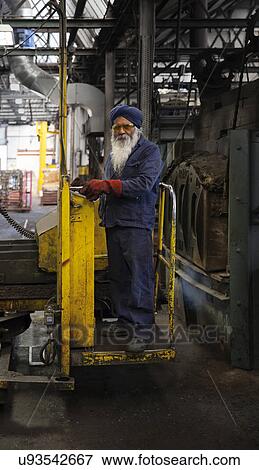 Stock Photo - Manipulator operative in heat treatment area. Fotosearch