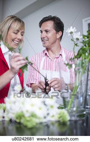 Mature couple arranging flowers in vase View Large Photo Image Stock Image - Mature couple arranging flowers in vase. Fotosearch
