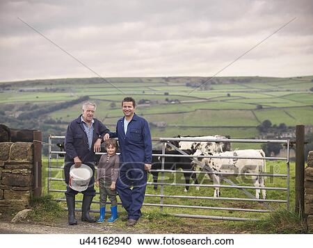 Mature farmer, adult son and grandson standing together at gate to cow field, portrait View Large Photo Image Stock Image - Mature farmer, adult son and grandson standing together at gate to cow field, portrait. Fotosearch