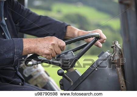 Mature farmer in tractor cab, close up View Large Photo Image Stock Photo - Mature farmer in tractor cab, close up. Fotosearch