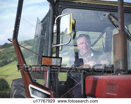 Stock Photo - Mature farmer in tractor cab, portrait. Fotosearch
