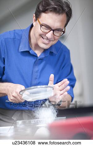 Stock Photo - Mature man baking. Fotosearch