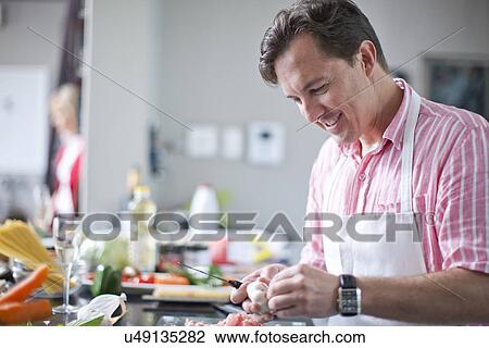 Mature man cooking, preparing ingredients View Large Photo Image Stock Image - Mature man cooking, preparing ingredients. Fotosearch