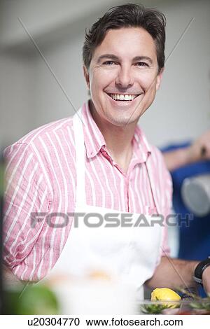 Mature man in kitchen wearing apron View Large Photo Image Stock Image - Mature man in kitchen wearing apron. Fotosearch