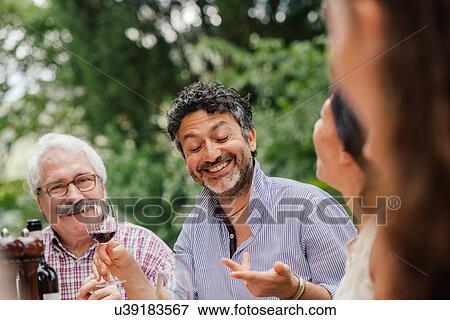 Mature man talking at outdoor meal View Large Photo Image Stock Photo - Mature man talking at outdoor meal. Fotosearch