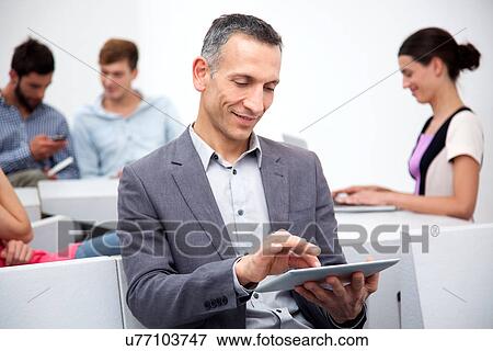 Mature man using digital tablet View Large Photo Image Stock Photo - Mature man using digital tablet. Fotosearch