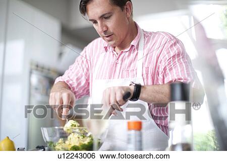 Mature men cooking, mixing ingredients in bowl View Large Photo Image Stock Photograph - Mature men cooking, mixing ingredients in bowl. Fotosearch