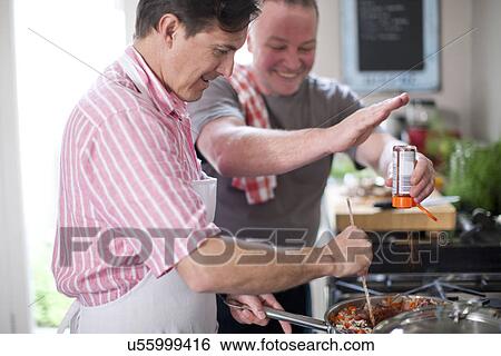 Mature men cooking, one stirring and one adding spices View Large Photo Image Stock Photograph - Mature men cooking, one stirring and one adding spices. Fotosearch