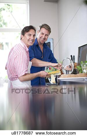 Stock Photo - Mature men cooking. Fotosearch