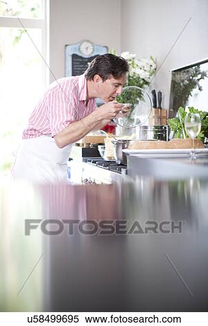 Mature men cooking, tasting food View Large Photo Image Stock Photography - Mature men cooking, tasting food. Fotosearch