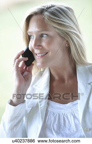 Stock Photograph - Mature woman on phonecall. Fotosearch