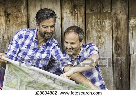 Stock Image - Men reading map. Fotosearch