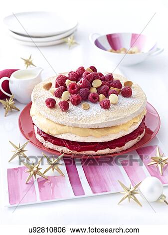 Stock Photograph - Meringue layer cake with raspberries and macadamia nuts. Fotosearch