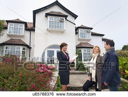 Mid adult couple and estate agent outside house View Large Photo Image Stock Photograph - Mid adult couple and estate agent outside house. Fotosearch