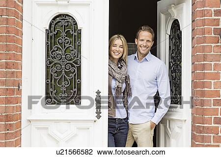 Mid adult couple by front door View Large Photo Image Stock Image - Mid adult couple by front door. Fotosearch