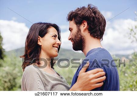 Stock Photo - Mid adult couple, face to face outdoors. Fotosearch