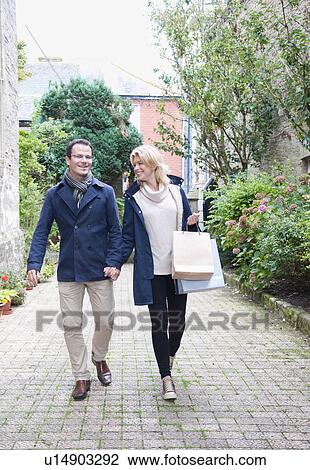 Mid adult couple going shopping View Large Photo Image Stock Image - Mid adult couple going shopping. Fotosearch