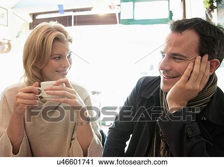 Mid adult couple in coffee shop View Large Photo Image Stock Image - Mid adult couple in coffee shop. Fotosearch