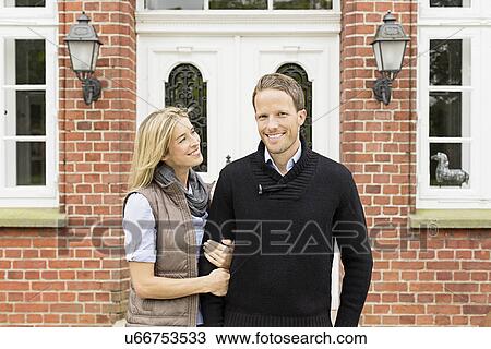 Mid adult couple outside house View Large Photo Image Stock Image - Mid adult couple outside house. Fotosearch
