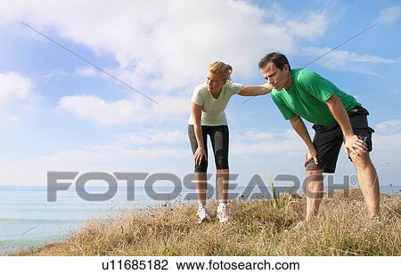Mid adult couple taking a break from exercise, Thurlestone, Devon, UK View Large Photo Image Stock Image - Mid adult couple taking a break from exercise, Thurlestone, Devon, UK. Fotosearch