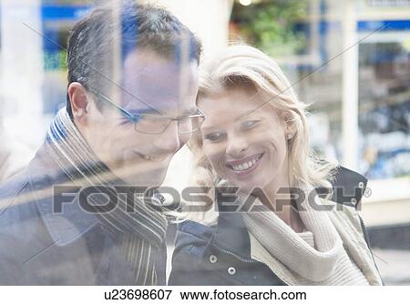 Mid adult couple window shopping View Large Photo Image Stock Photo - Mid adult couple window shopping. Fotosearch