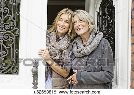 Mother and daughter by front door View Large Photo Image Stock Photography - Mother and daughter by front door. Fotosearch