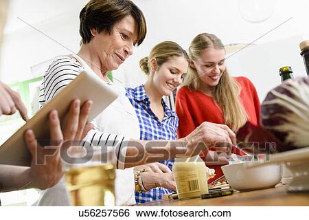 Mother and daughters preparing food View Large Photo Image Stock Photograph - Mother and daughters preparing food. Fotosearch