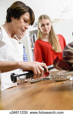Stock Photography - Mother and daughters preparing food. Fotosearch