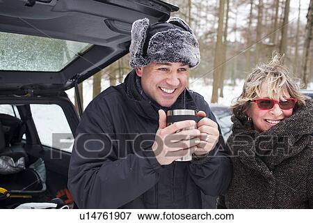 Mother and son having hot drink outside in winter View Large Photo Image Stock Photo - Mother and son having hot drink outside in winter. Fotosearch
