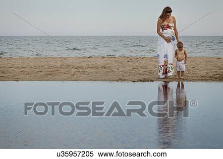 Stock Photography - Mother and toddler looking down at reflections. Fotosearch