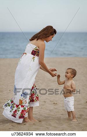 Mother and toddler standing on beach View Large Photo Image Picture - Mother and toddler standing on beach. Fotosearch