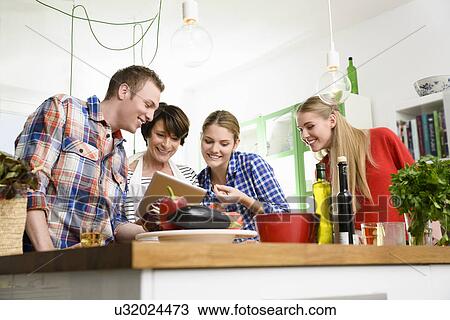 Mother, daughters and son preparing food View Large Photo Image Stock Image - Mother, daughters and son preparing food. Fotosearch