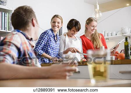 Mother, daughters and son preparing food in kitchen View Large Photo Image Stock Image - Mother, daughters and son preparing food in kitchen. Fotosearch