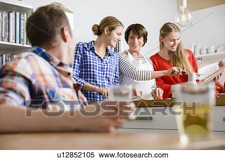 Mother, daughters and son preparing food in kitchen View Large Photo Image Stock Photography - Mother, daughters and son preparing food in kitchen. Fotosearch