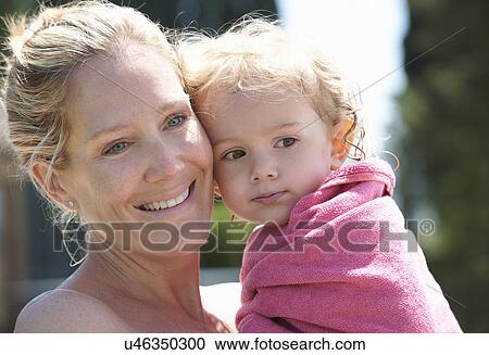 Mother holding toddler wrapped in towel View Large Photo Image Stock Image - Mother holding toddler wrapped in towel. Fotosearch