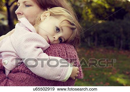 Stock Photo - Mother hugging daughter. Fotosearch