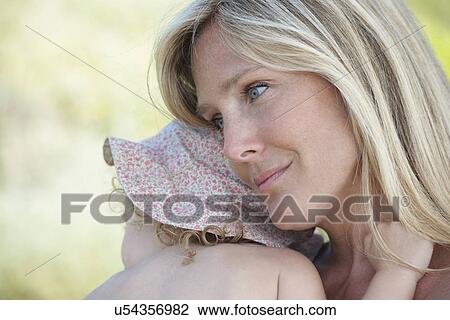 Mother hugging toddler wearing sunhat View Large Photo Image Stock Image - Mother hugging toddler wearing sunhat. Fotosearch