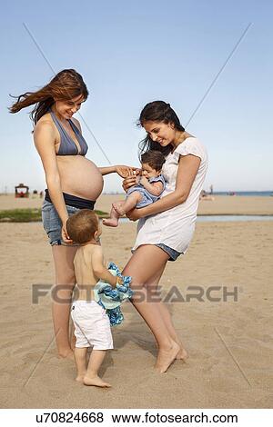 Mothers and children standing on beach View Large Photo Image Stock Photo - Mothers and children standing on beach. Fotosearch