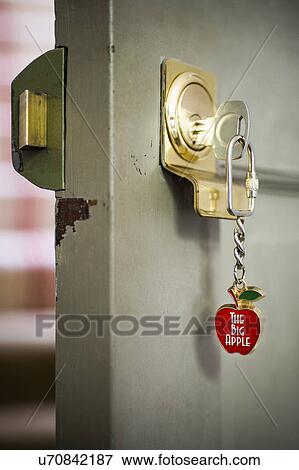 Open front door with key and souvenir keyring View Large Photo Image Stock Photo - Open front door with key and souvenir keyring. Fotosearch