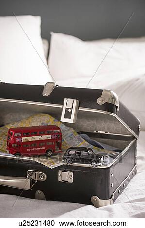 Open suitcase on bed with toy London bus and black cab View Large Photo Image Stock Image - Open suitcase on bed with toy London bus and black cab. Fotosearch