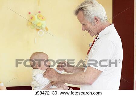 Paediatrician examining baby girl, holding hands View Large Photo Image Stock Image - Paediatrician examining baby girl, holding hands. Fotosearch